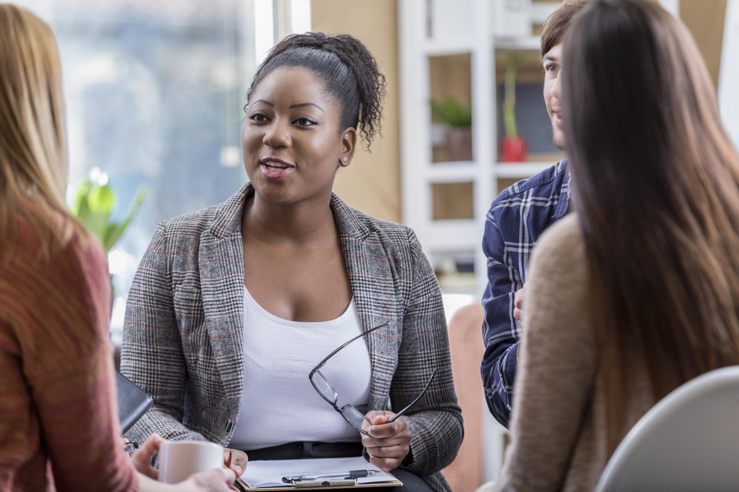 woman leads group therapy session