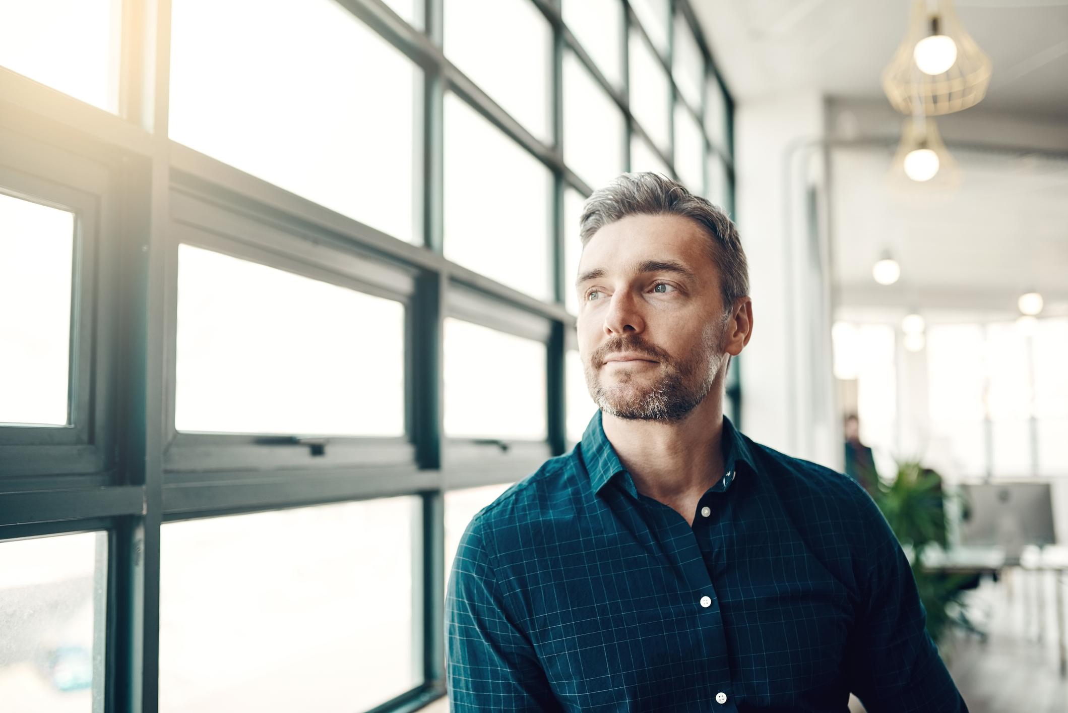 man looking out of window